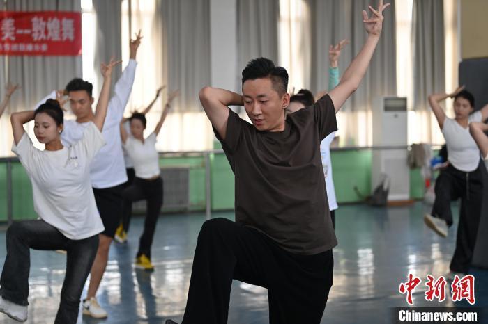 6月6日，在甘肅敦煌青年夜校課程中，青年學(xué)員學(xué)習(xí)敦煌舞課程。李亞龍 攝　　